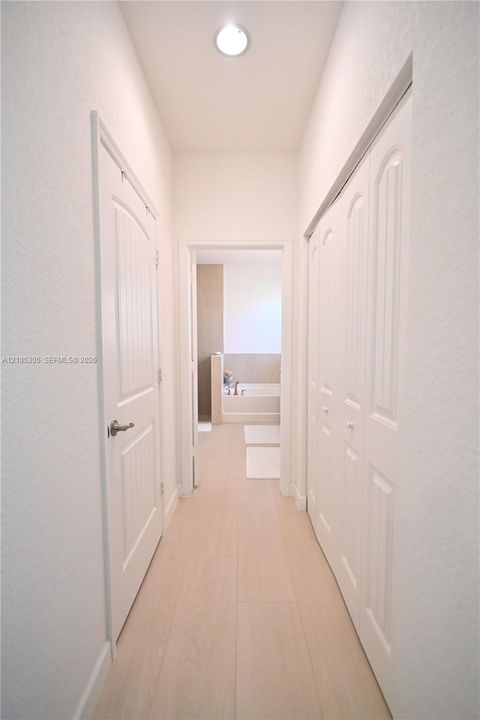 Recessed ceiling light, paneled interior doors, wood-finish flooring, bi-fold closet doors, and light wall finishes