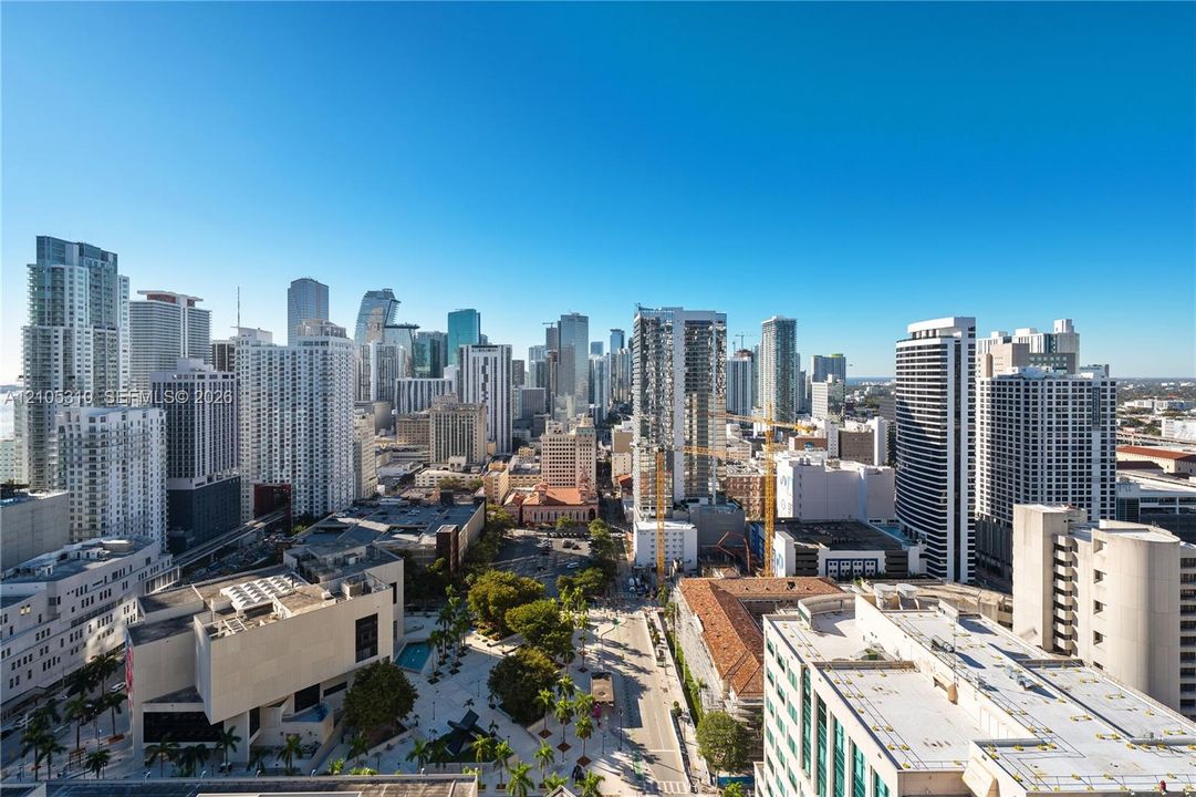 Expansive urban skyline with numerous high-rise buildings and visible waterways