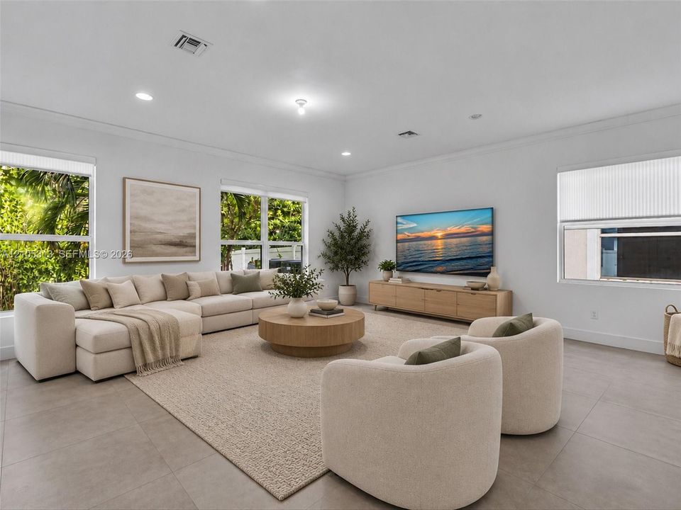 Virtually staged. Large-format tile flooring, recessed lighting, and multiple windows with integrated window treatments