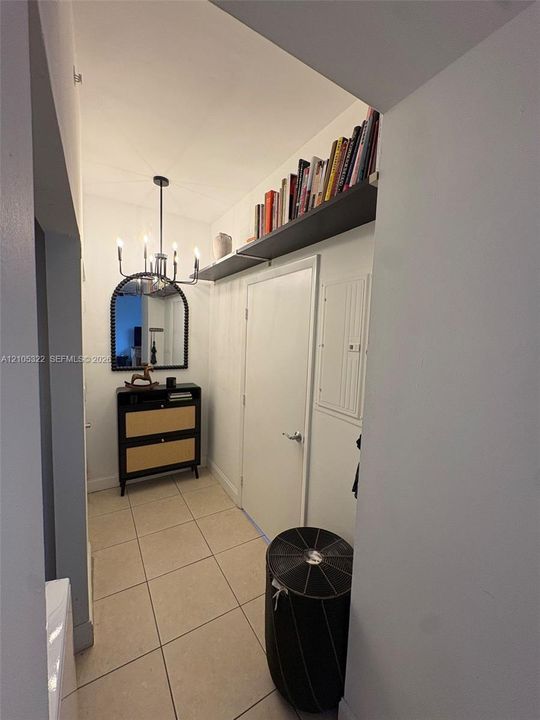 Recessed lighting, tile flooring, and built-in shelving