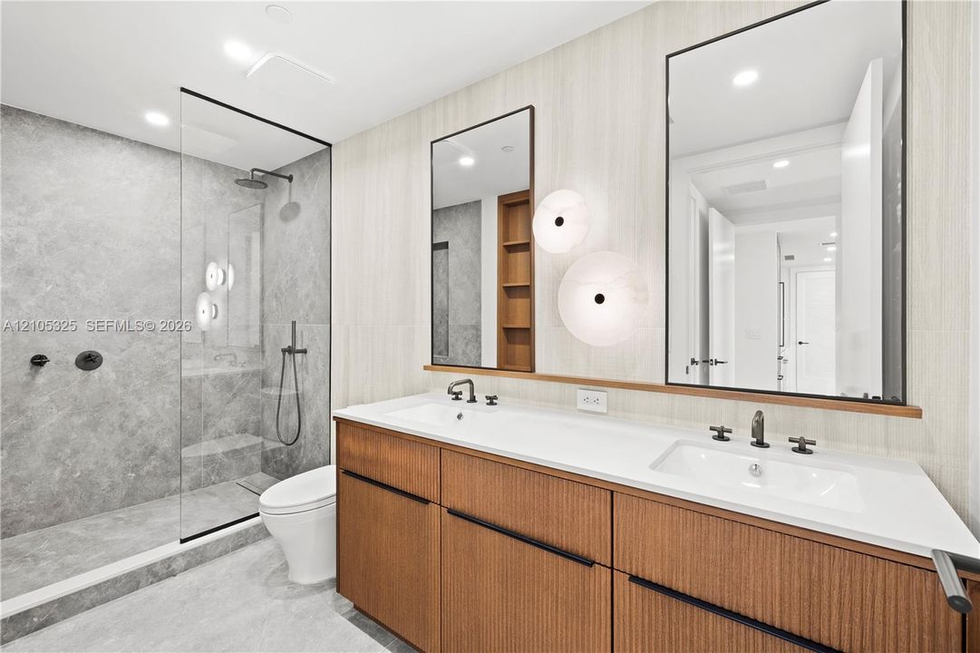 Dual vanity with white countertop, integrated sinks, and matte black fixtures