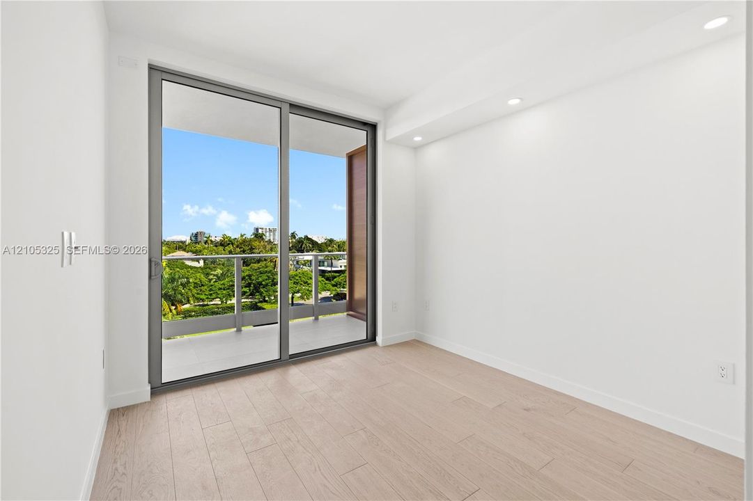 Sliding glass doors opening to a private balcony with metal railings
