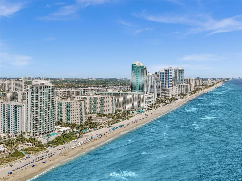 Experience luxury oceanfront living at Apogee Beach, featuring direct beach access, resort-style pools, and amenities, and exceptional coastal lifestyle.