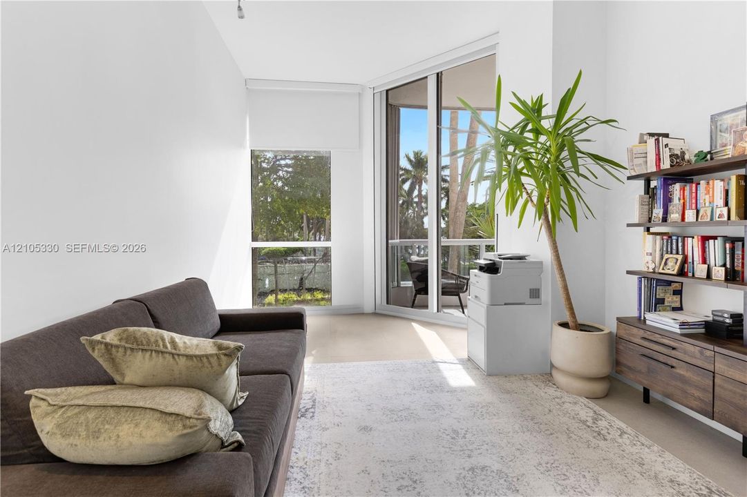 Full-height sliding glass doors, a corner window, and a built-in shelving unit