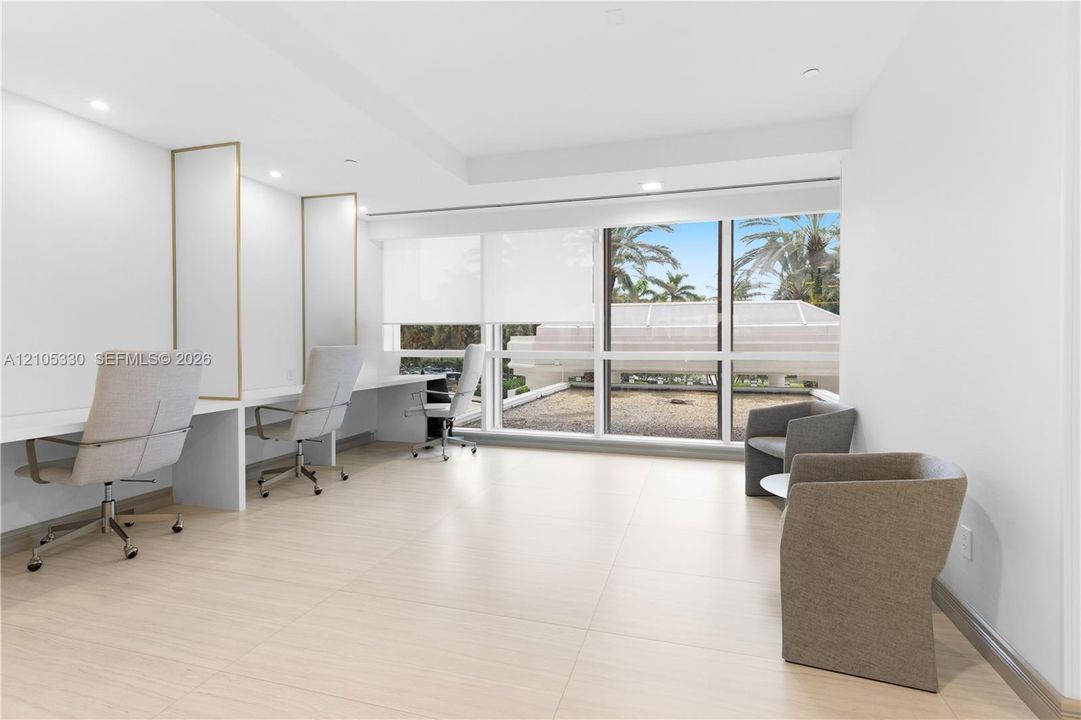 Recessed lighting, wood-finish flooring, full-height windows, and built-in desk space