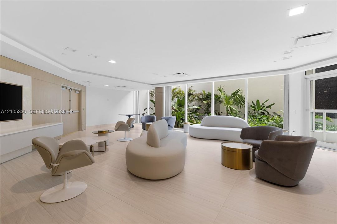 Recessed lighting, wood-finish wall panels, and large-format tile flooring