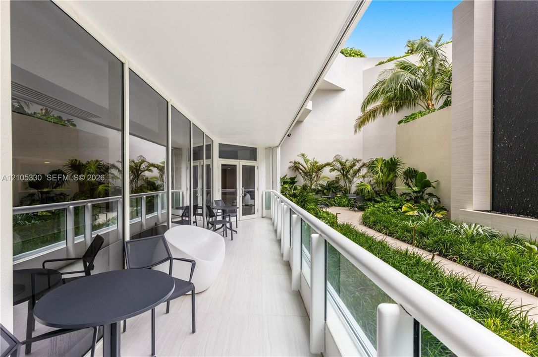 Outdoor patio with wood-finish flooring and glass railing