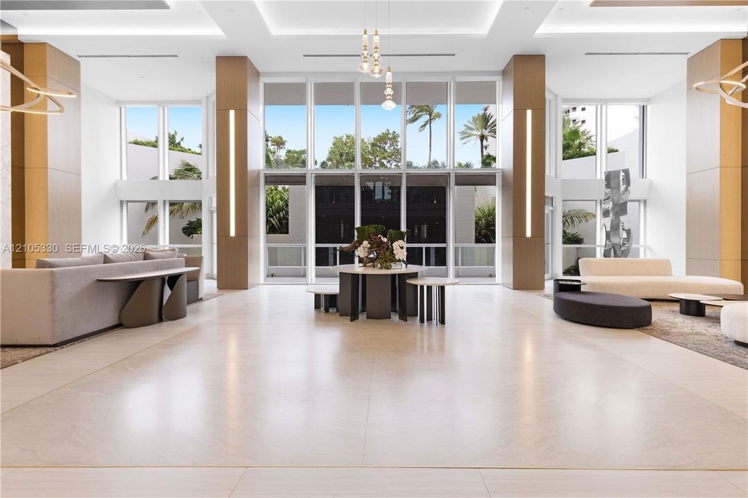 Spacious common area featuring large format tile flooring, extensive floor-to-ceiling windows, and recessed ceiling lighting