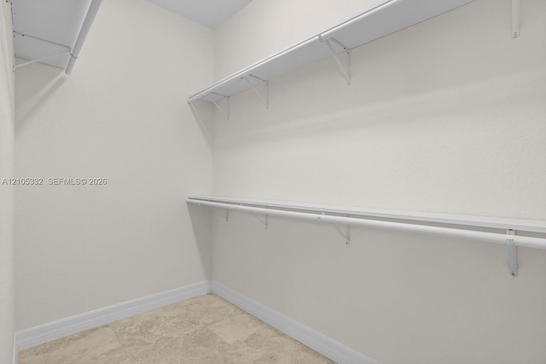 Built-in white wire shelving and hanging rods
