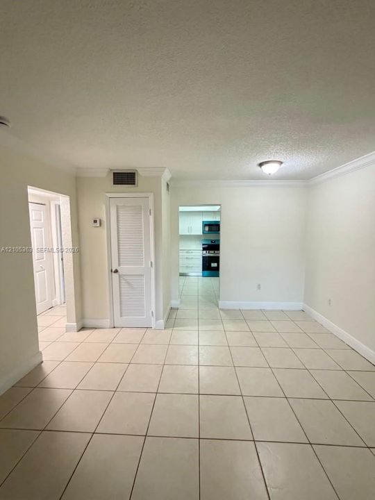 Tile flooring, white walls, white doors, and crown molding