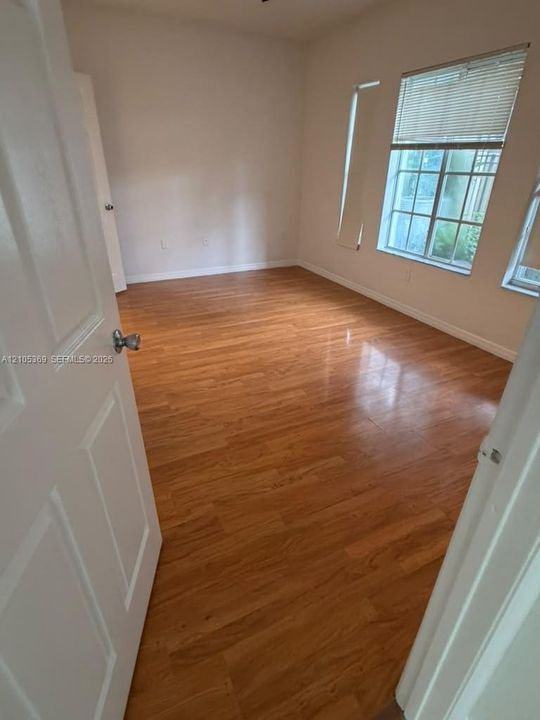 Wood-finish flooring with white trim and neutral wall tones