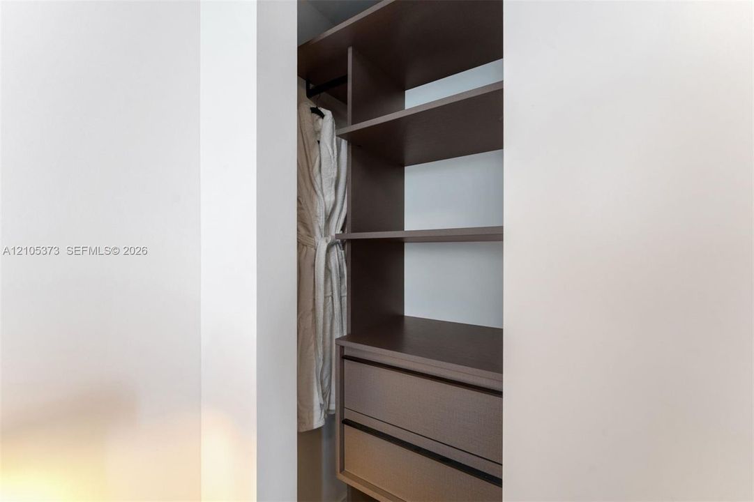 Built-in closet system featuring multiple shelving units and integrated drawers