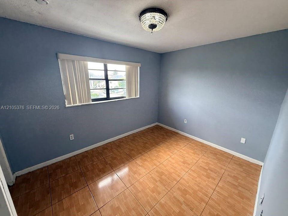 Blue-painted walls with a window featuring horizontal blinds