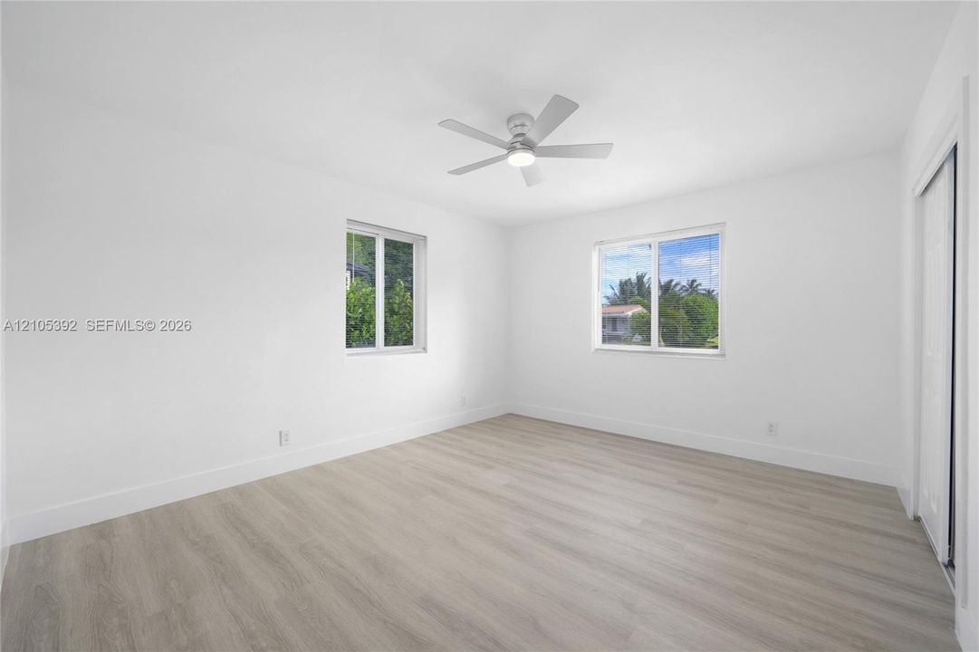 Light wood-finish flooring with white walls