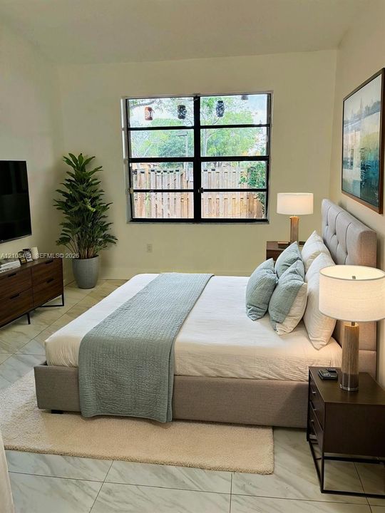 Large-format tile flooring paired with a multi-pane grid window and neutral wall finishes