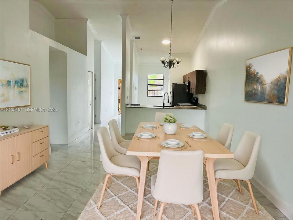 Open-concept dining area featuring stone-finish tile flooring, vaulted ceilings, and a kitchen pass-through counter with a high-arch faucet and dark cabinetry