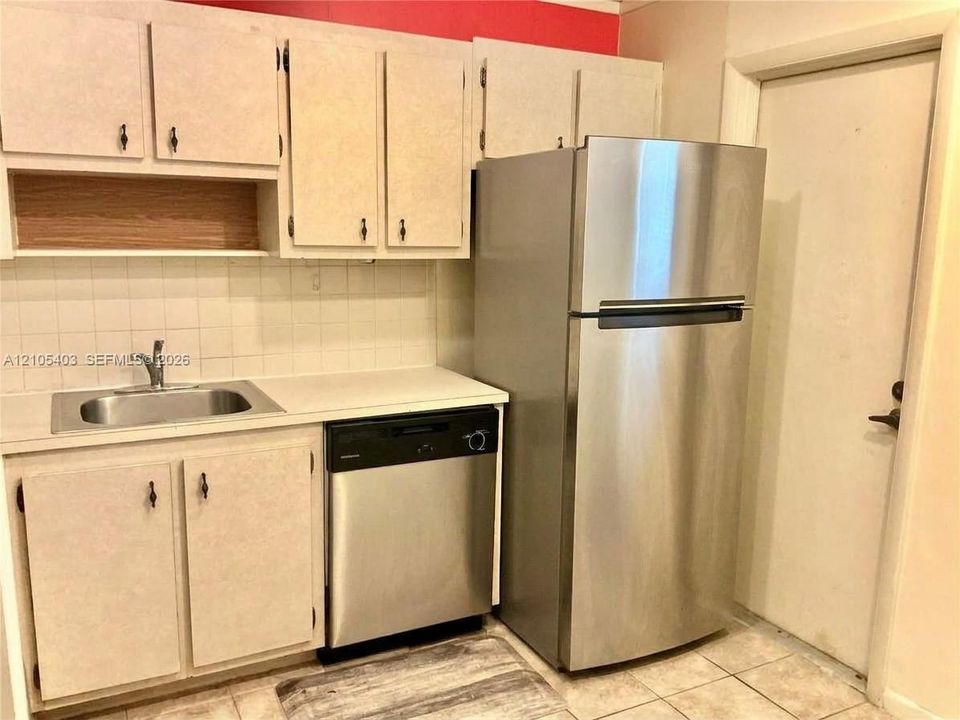 Kitchen featuring stainless steel refrigerator, stainless steel dishwasher, and a stainless steel sink