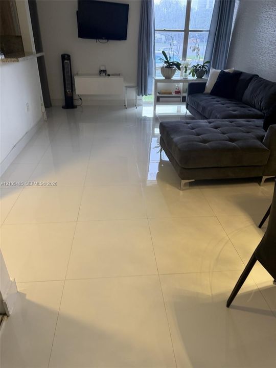 White tile flooring extends throughout the space