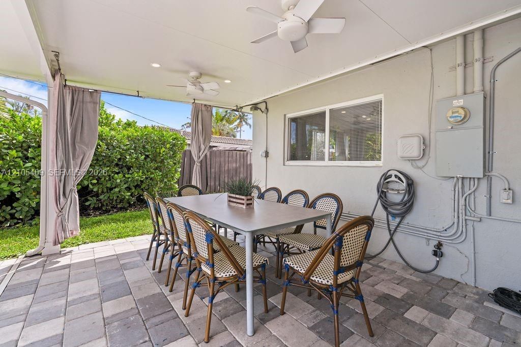 Covered patio area featuring ceiling fans and recessed lighting