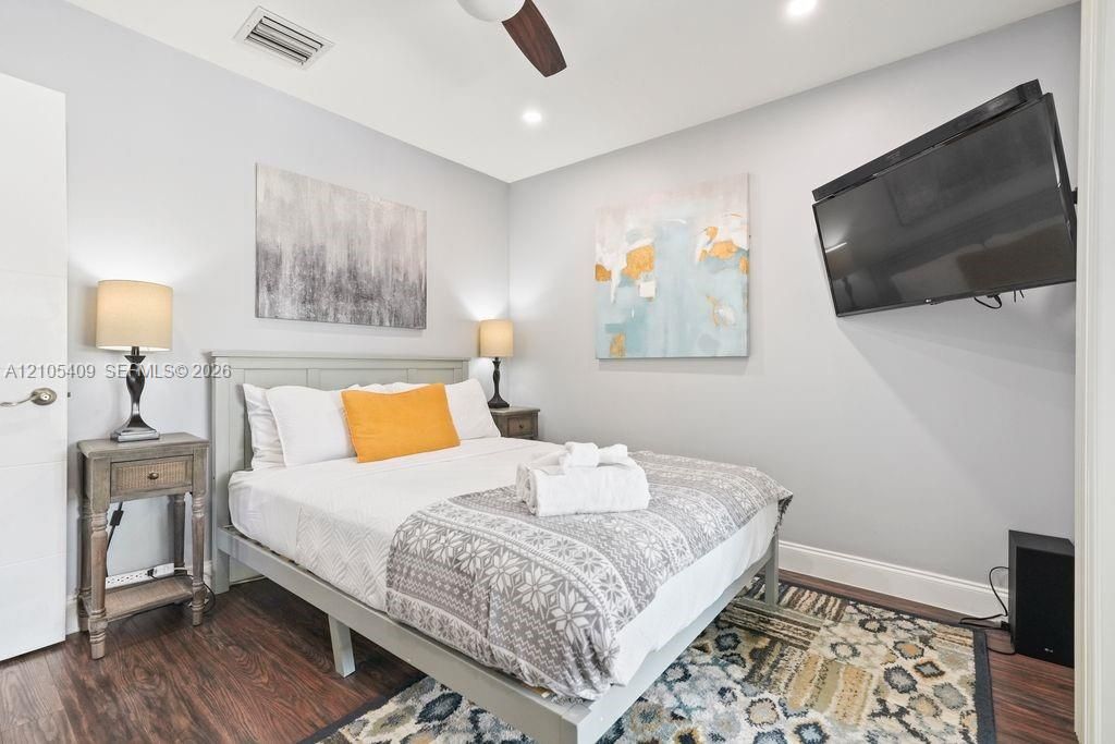 Wood-finish flooring, recessed lighting, and a ceiling fan