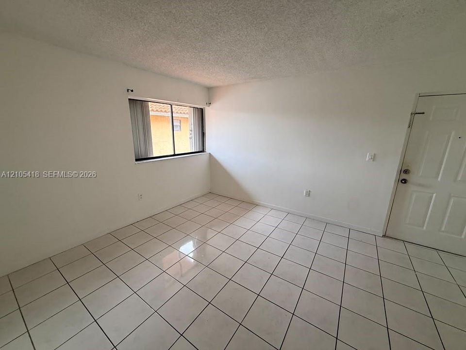 White tile flooring and a textured ceiling