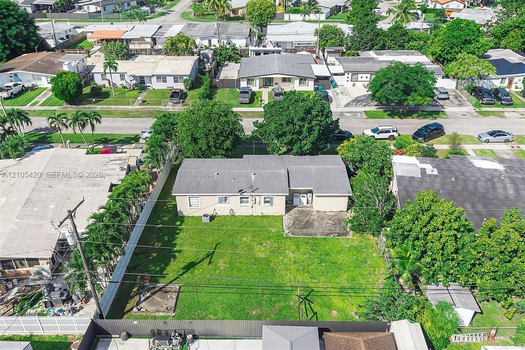 Expansive grass lawn with perimeter fencing