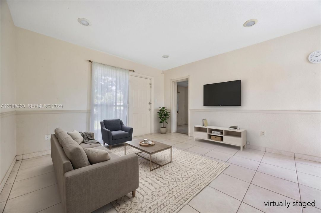 Recessed ceiling lighting, tiled flooring, and a window with sheer curtains