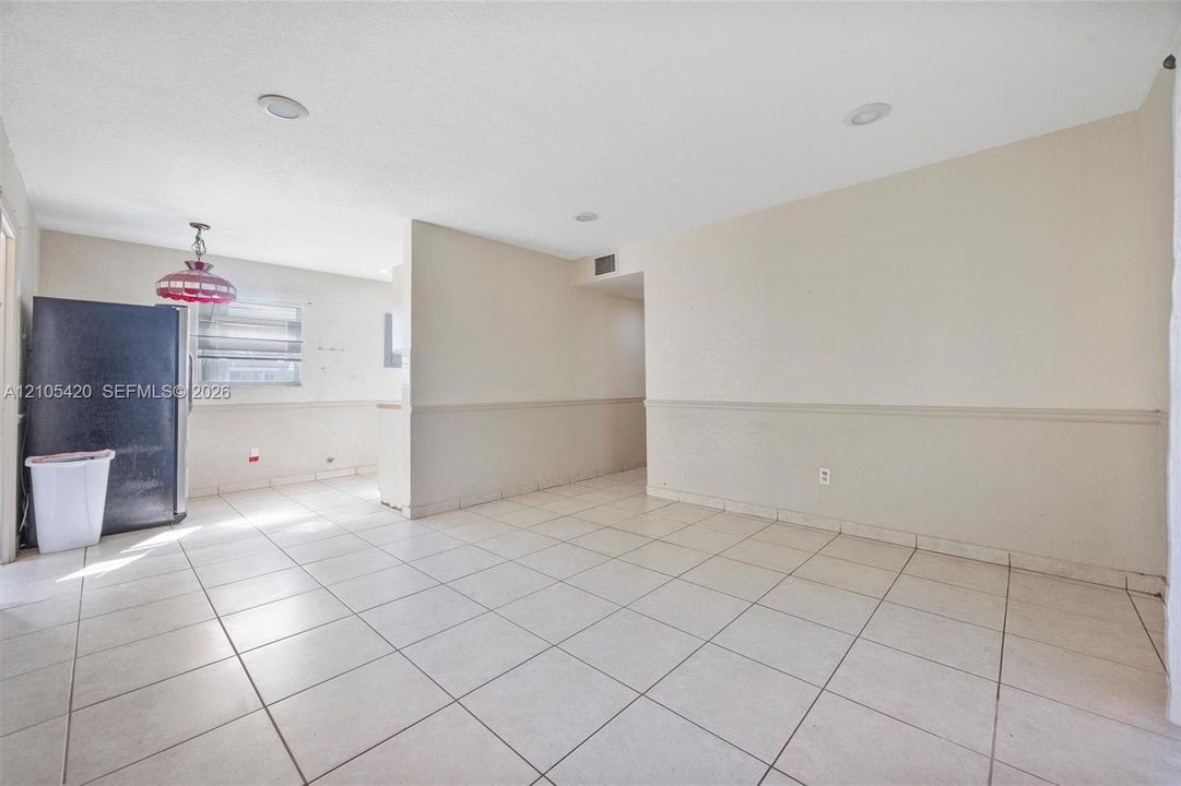 Tile flooring throughout, recessed lighting, and chair rail molding