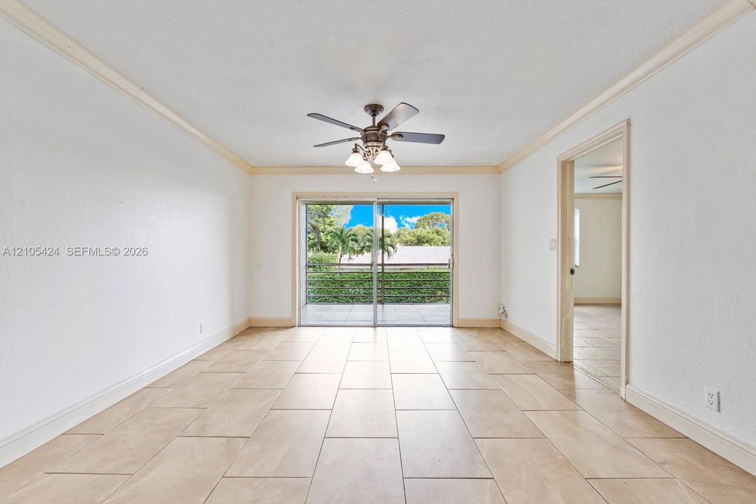 Tile flooring throughout, crown molding, and direct access to an outdoor patio space