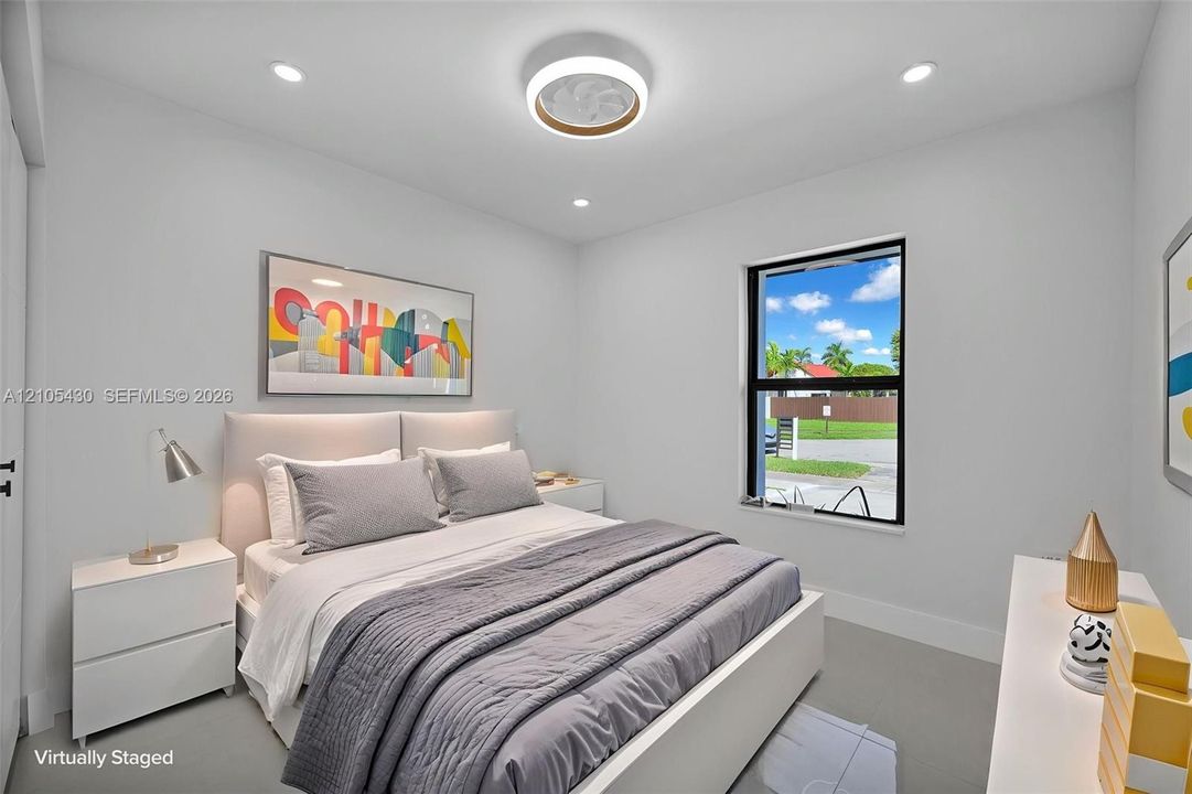 Neutral interior featuring recessed lighting, a contemporary circular flush-mount ceiling fixture, and a single-pane window