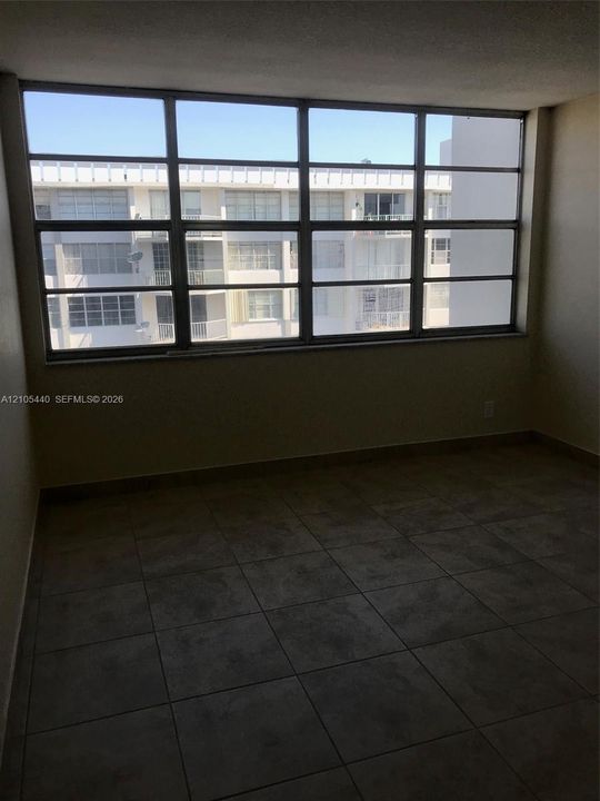 Expansive window offering abundant natural light and tile flooring