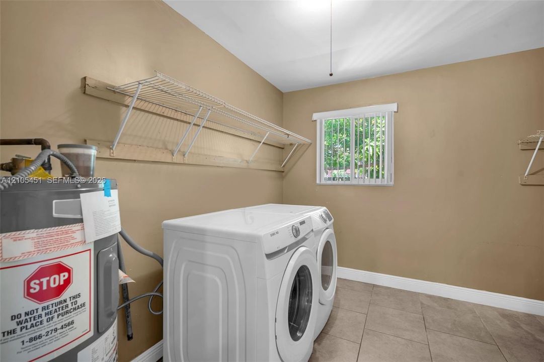 Tile flooring, window with vertical blinds, and wall-mounted wire shelving