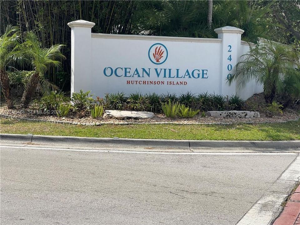 Community entry monument with "OCEAN VILLAGE" and "HUTCHINSON ISLAND" signage