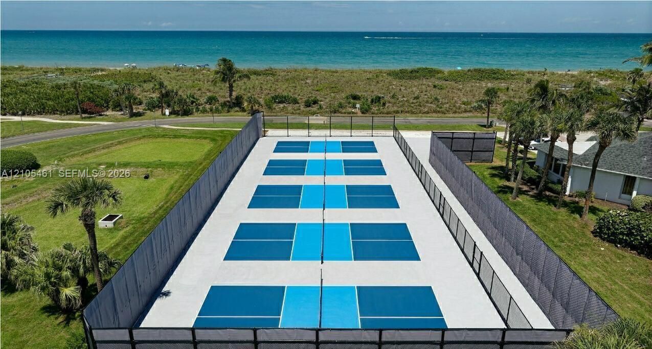 Multiple pickleball courts with blue and light blue playing surfaces