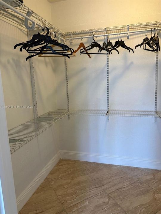 Integrated closet shelving system with hanging rods and tile flooring