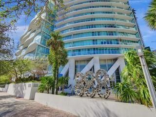 Modern high-rise building with curved glass balconies and a unique architectural facade