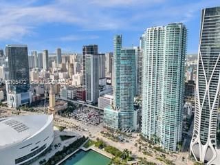 Vast cityscape with numerous high-rise buildings, including distinctive architectural structures