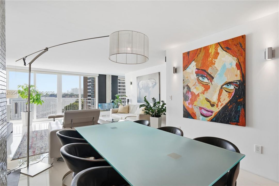 Floor-to-ceiling glass doors, white tile flooring, and recessed wall lighting