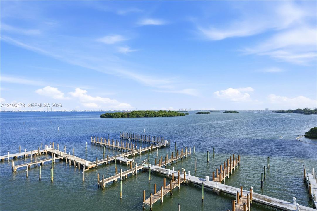 Waterfront setting with multiple docking slips and distant city skyline