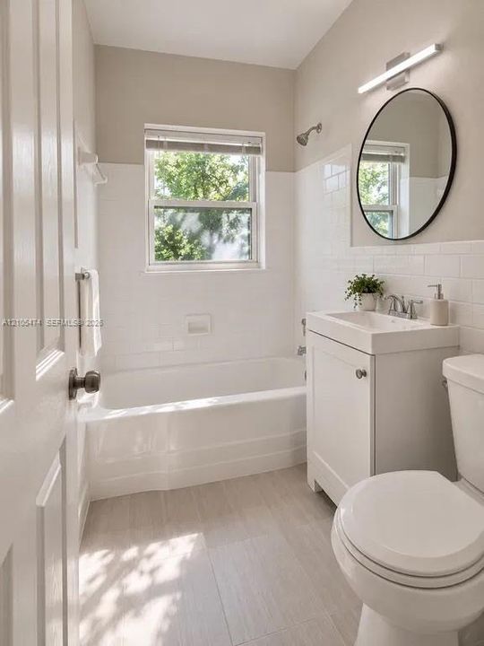 Bathroom featuring a white subway tile surround, neutral wall paint, and light-toned tile flooring