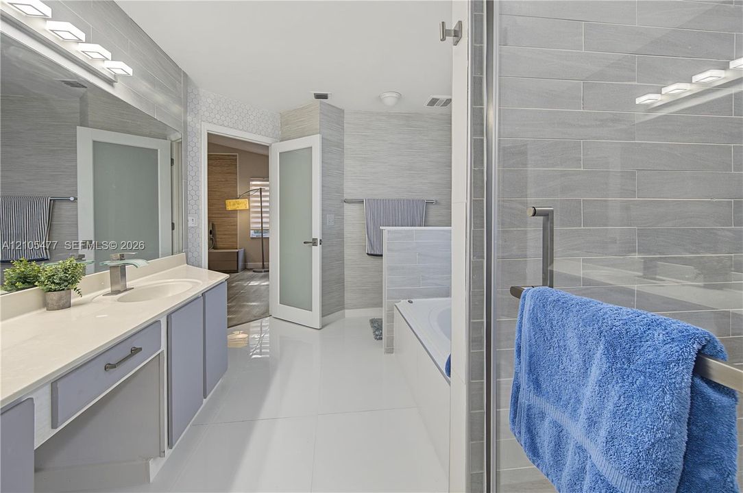 Dual vanity with undermount sinks, quartz countertop, and brushed nickel fixtures