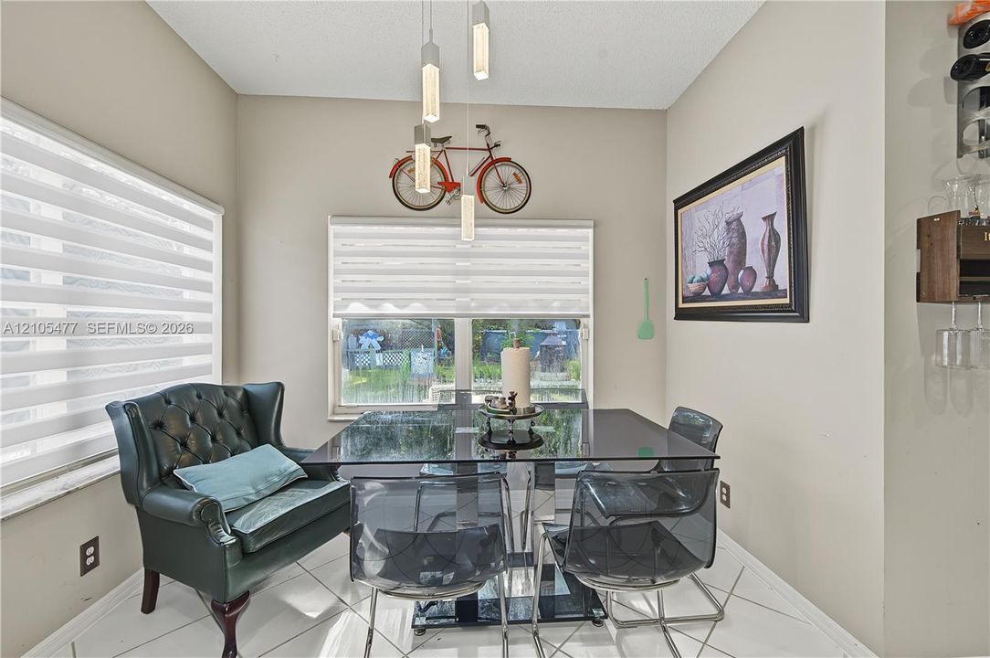 Recessed lighting, tile flooring, and multiple windows with horizontal blinds