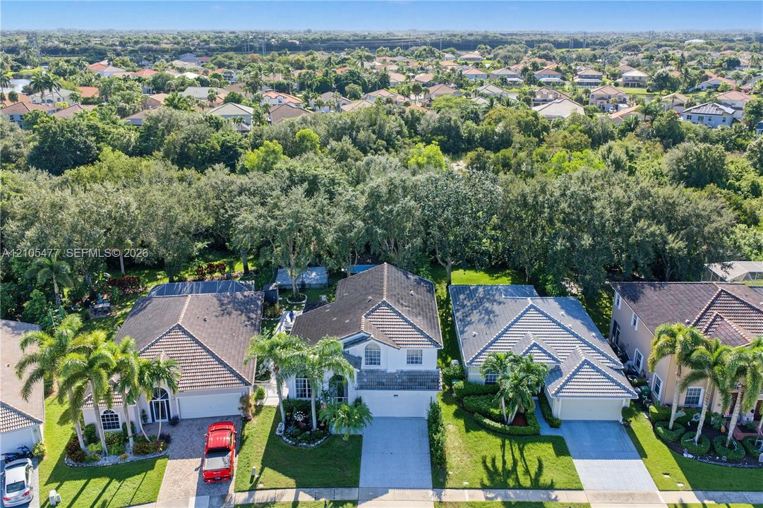 Aerial perspective showcasing a residential neighborhood with lush landscaping