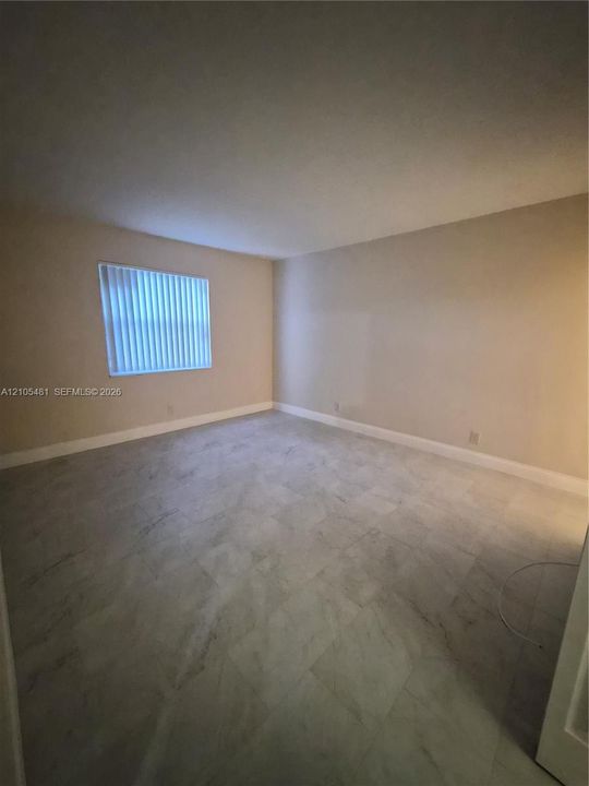 Hard surface flooring, neutral wall tones, and horizontal blinds