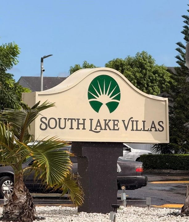 Monolithic community signage featuring a stylized sunburst emblem and professional lettering