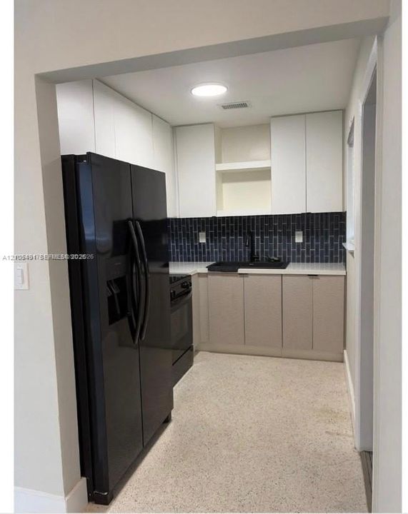 White exterior with dark trim accents, modern black mailbox, and dark front door
