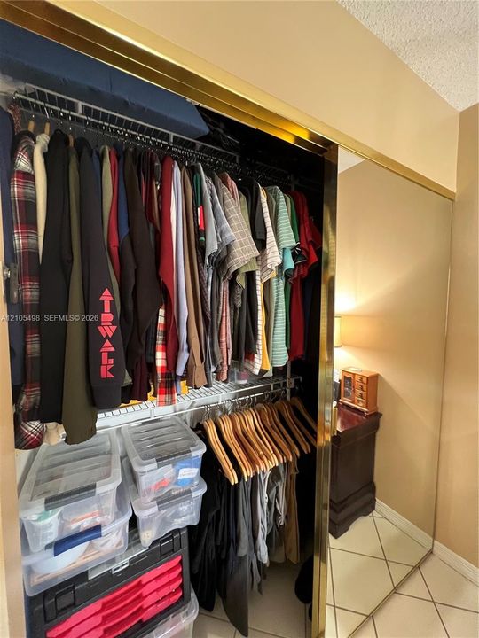 One closet of two in primary bedroom