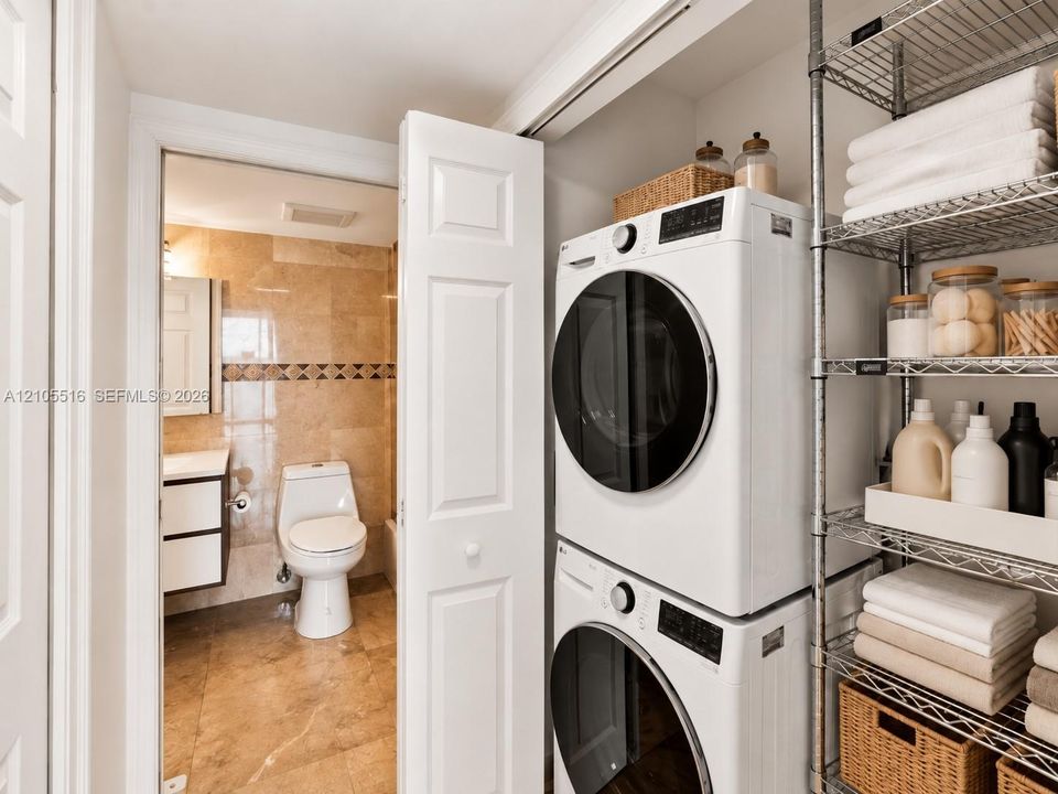 Stacked laundry appliances with adjacent wire shelving