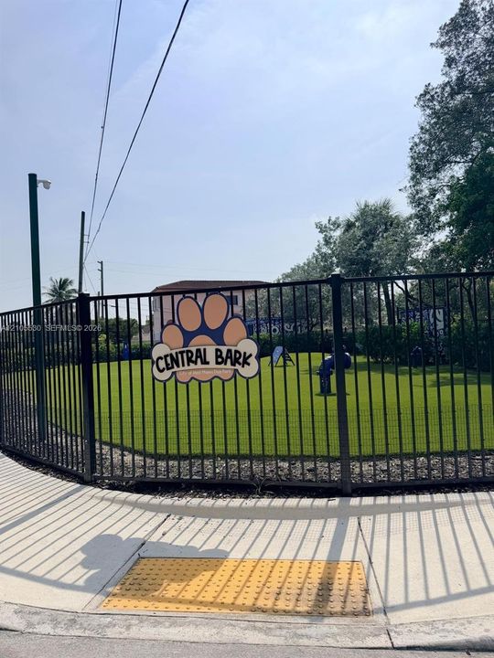 Fenced recreational area featuring artificial turf