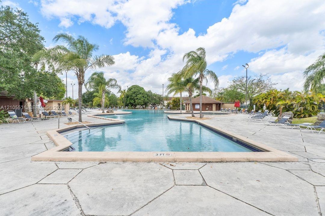 Expansive, free-form swimming pool with integrated spa